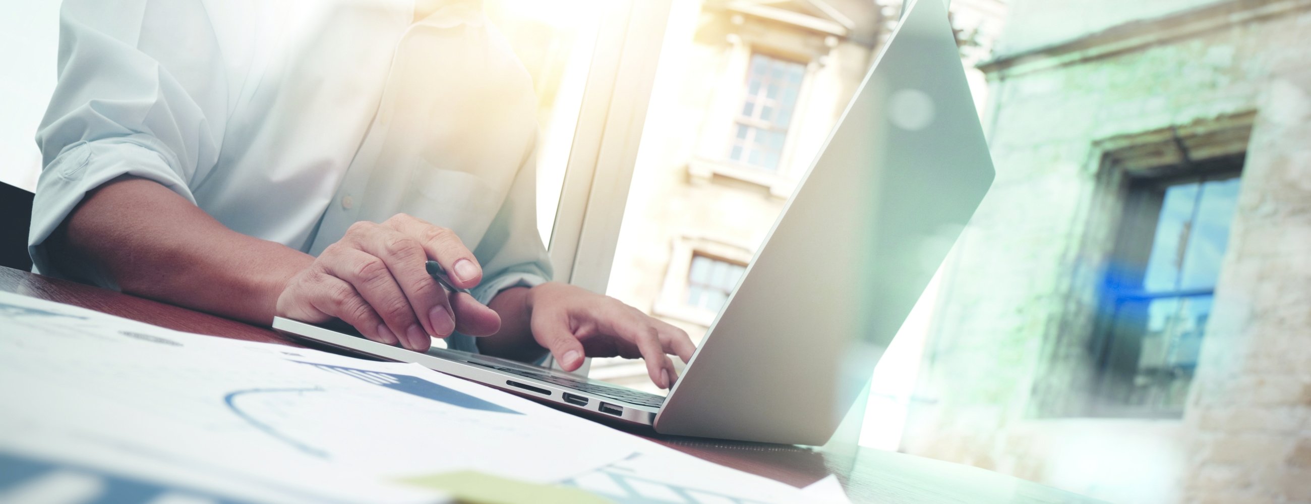 business documents on office table with smart phone and digital tablet and graph business diagram and man working in the background
